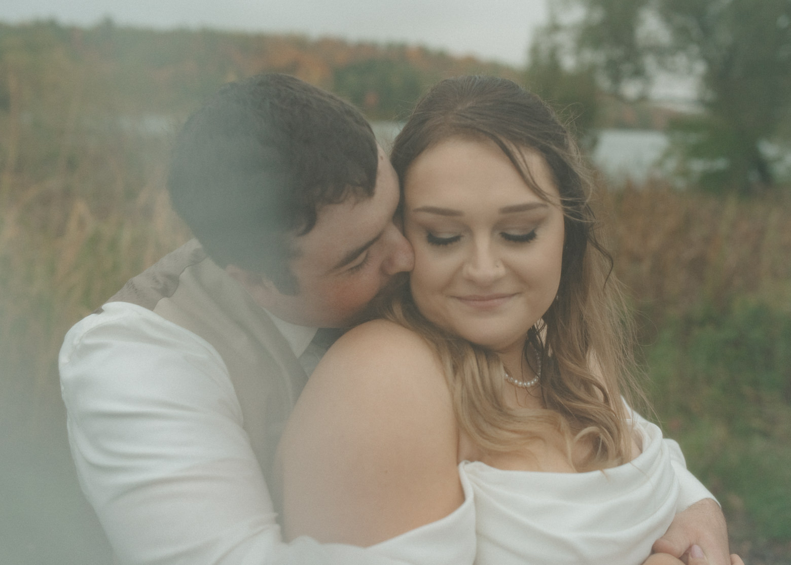 Bride and groom embrace on their fall wedding day in Coleraine, Minnesota.